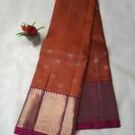 Rust Orange Silk Saree with All-Over Gold Zari Buttas & Contrast Magenta Border