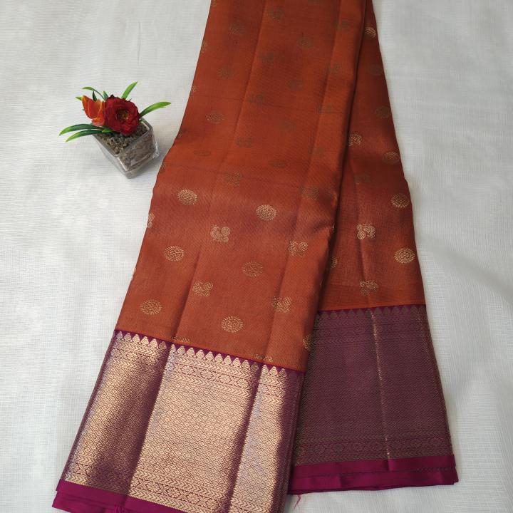 Rust Orange Silk Saree with All-Over Gold Zari Buttas & Contrast Magenta Border