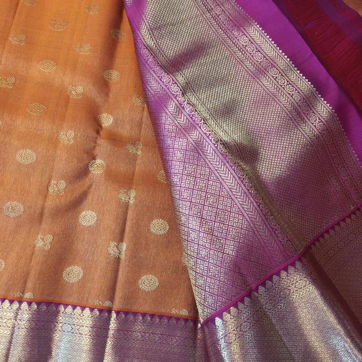 Rust Orange Silk Saree with All-Over Gold Zari Buttas & Contrast Magenta Border